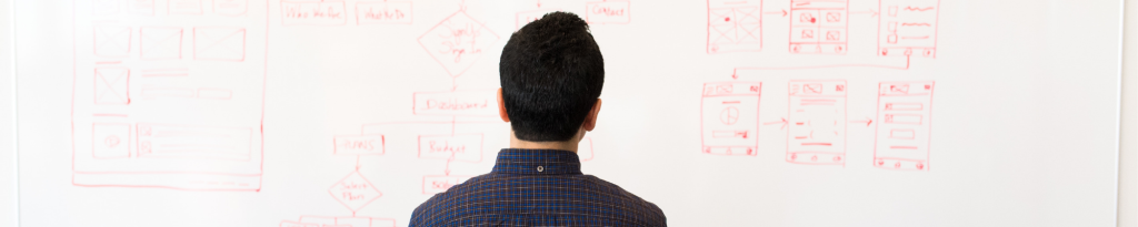 man in front of whiteboard